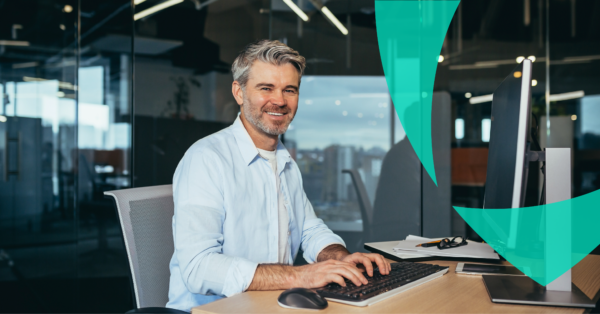 Smiling man working in an office representing interim professionals and claims management expertise by Van Ameyde