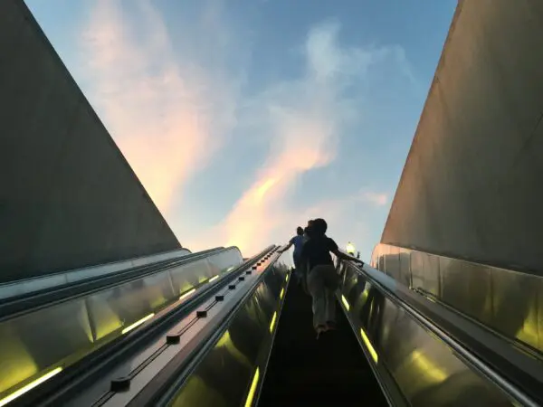 People on electric stairs at a construction and engineering site representing infrastructure and project risk management by Van Ameyde